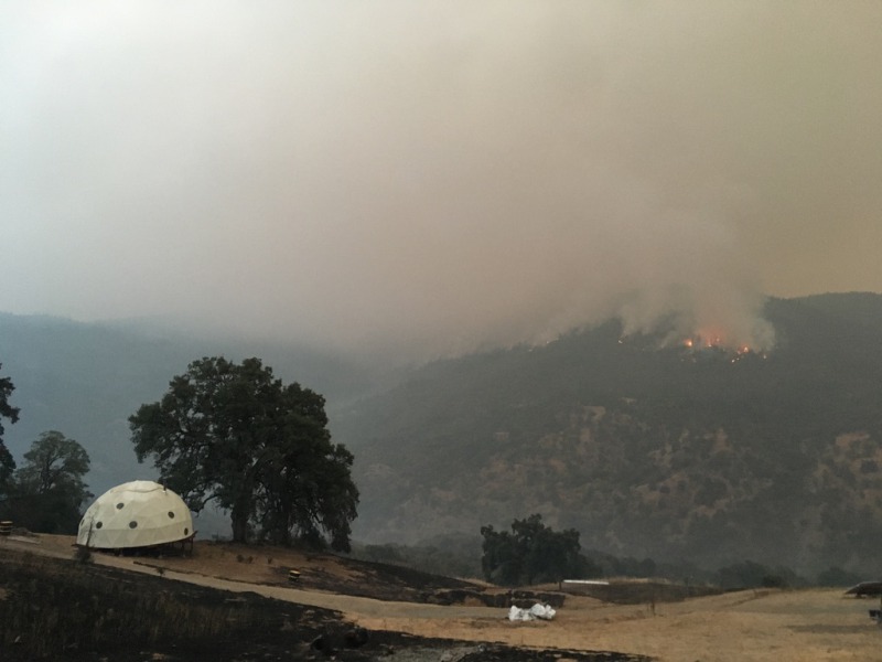Mexico Ridge burning above the geodesic dome situated on Wildland Cannabis's property.