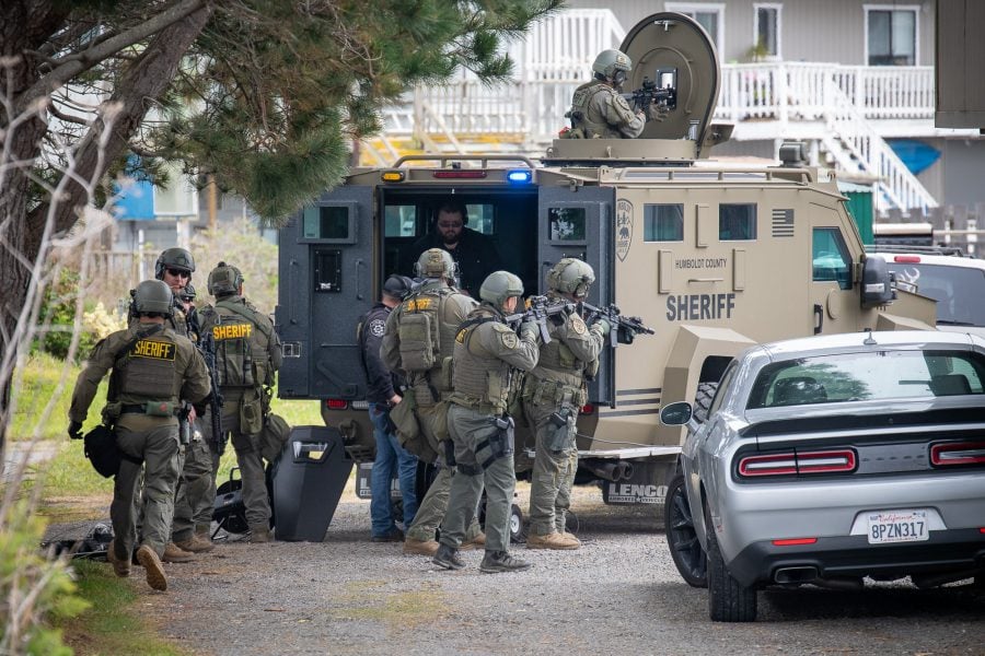McKenna Members of the Humboldt County Sheriff’s Department SWAT team take cover behind a Bear Cat armored vehicle.