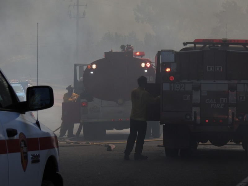 Fire personnel smothered in smoke.