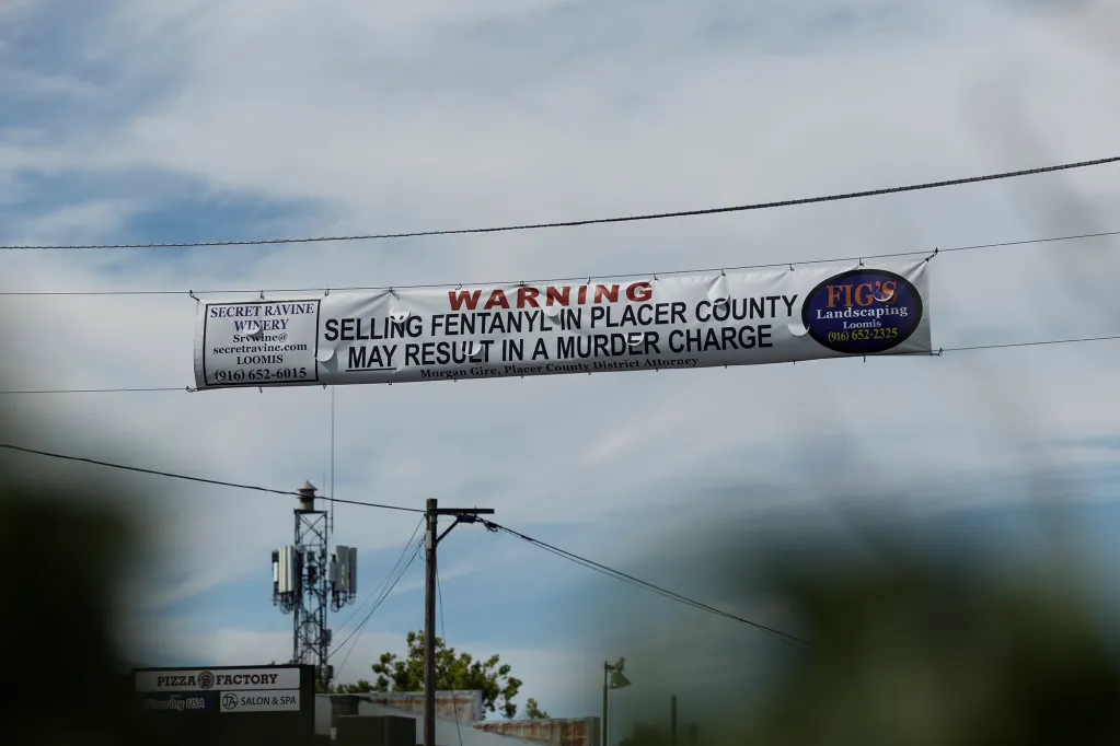 A sign warning against selling fentanyl in Placer County hangs over Taylor Road in Loomis on July 24, 2023. Photo by Miguel Gutierrez Jr., CalMatters