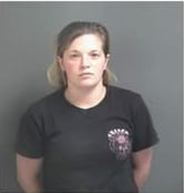 Arrest photo of woman in black tshirt.