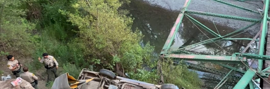 An overturned vehicle rests amid the wreckage after the Hill Road Bridge over Mill Creek gave way beneath it Friday evening. CHP reported the driver suffered minor injuries despite the dramatic collapse.