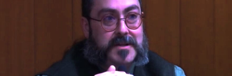 Man speaking at a microphone