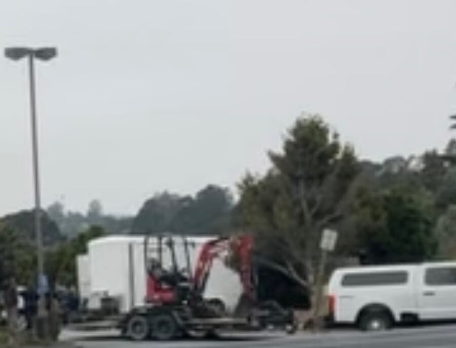 A mini excavator is transported to the Miranda's Rescue property Tuesday morning as the Humboldt County Sheriff's Office executes a search warrant in its ongoing investigation. Investigators also brought a Bobcat skid steer to the scene as authorities continued processing the property. Photo: Courtesy of Jenna Moore.