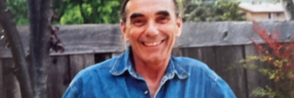smiling older man in denim shirt
