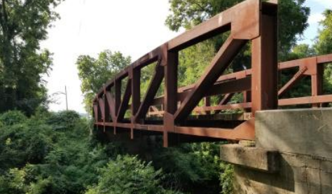 The replacement envisioned for the Green Bridge project would have traded the familiar narrow crossing for a wider, modern structure designed to safely accommodate today's traffic and emergency vehicles. The image shows a rendering of the proposed replacement bridge planned for the Mill Creek crossing.