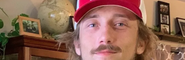 Man in a red ball cap.