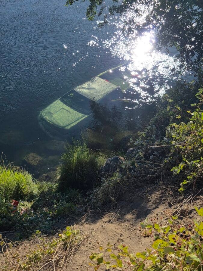 the GMC Sierra beneath the surface of the Trinity River after the solo-vehicle crash.Photo 3: