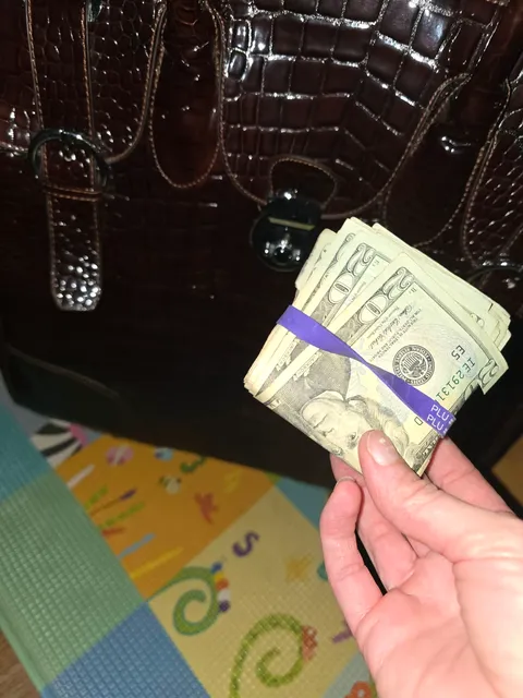 A dusty bundle of $20 bills totaling $1,000 was tucked inside a pocket of the donated travel bag. Teagan and her mother tracked down the owner and returned the money. [Photo courtesy of Jeni Stevens]