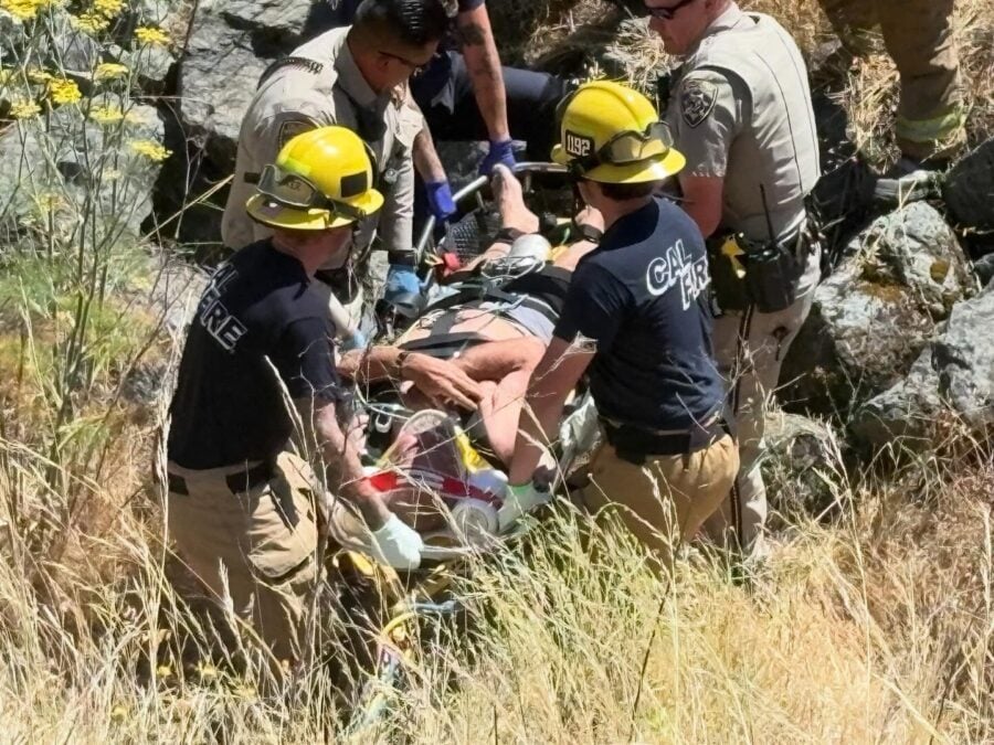 Emergency responders prepare to raise an injured driver up the embankment following a rollover crash that sent a vehicle approximately 50 yards off Highway 101 south of Hopland. [Photo from CHP]